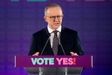 Anthony Albanese standing in front of "VOTE YES" branding as he announces the date of the Voice to Parliament referendum