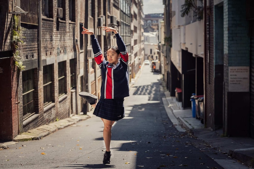Grace Huynh dancing in an alleyway.