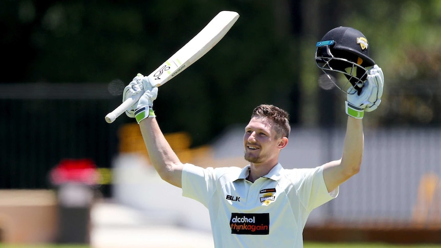 Cameron Bancroft raises his bat to acknowledge the WACA crowd after reaching his double century.