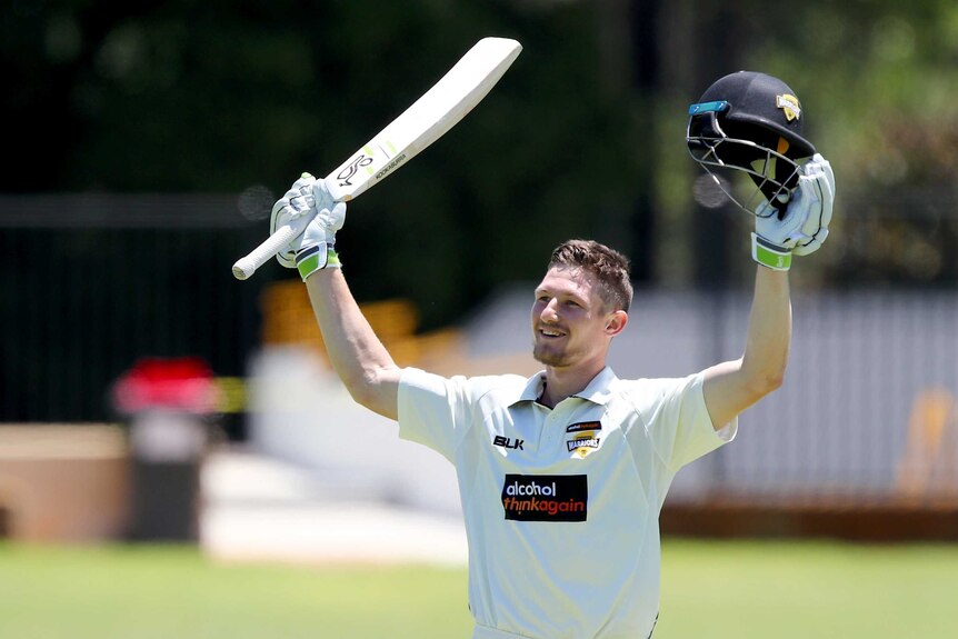 Cameron Bancroft raises his bat to acknowledge the WACA crowd after reaching his double century.