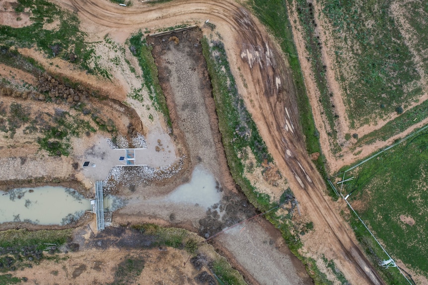 An aerial shot of a property including roads and water channels.