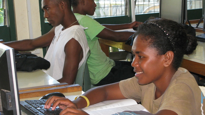 A Solomon Islands woman using a computer