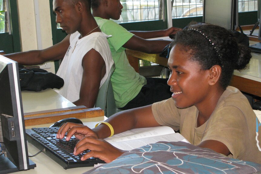A Solomon Islands woman using a computer