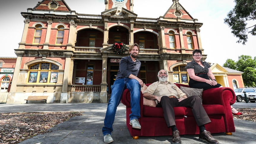 The Star Cinema with Business Manager Martin Myles, actor John Flaus and board chair Fiona McMahon sitting on a couch out front.