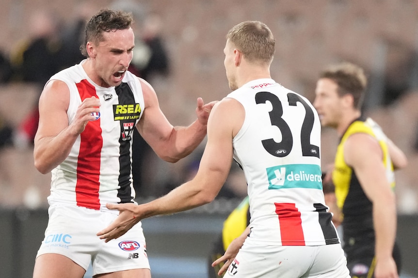 Two St Kilda AFL players celebrate a goal against Richmond.