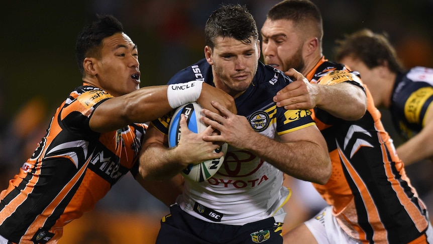 North Queensland's Lachlan Coote takes the ball up against Wests Tigers at Campbelltown.