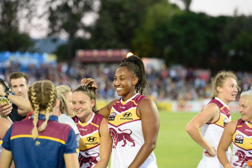 Sabrina Frederick-Traub of the Lions (C) celebrates after Brisbane's AFLW win over Adelaide.
