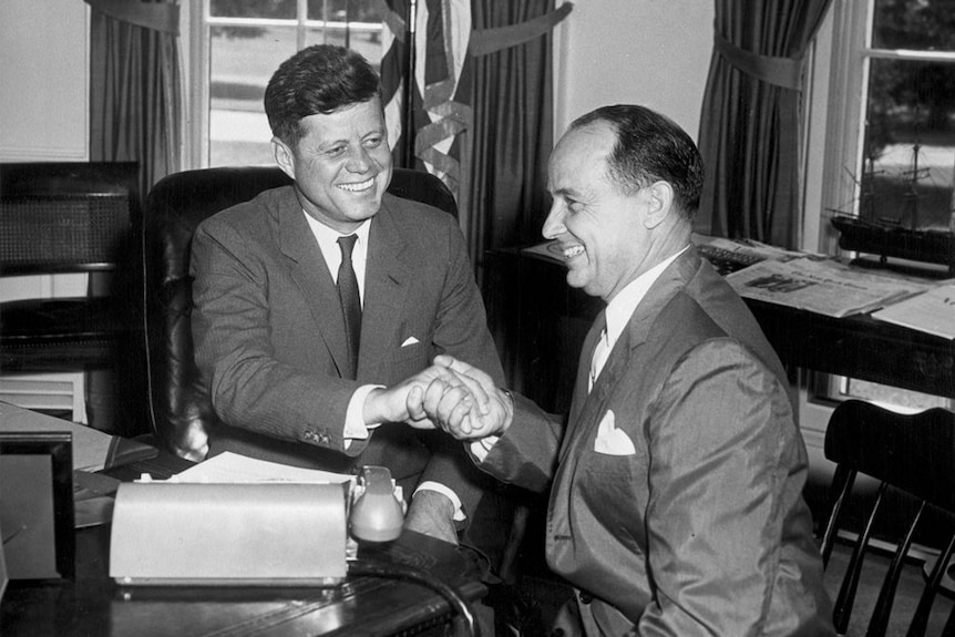 John F. Kennedy and Chep Morrison share an awkward handshake in 1961.
