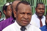 PNG politician Belden Namah walks to Government House in Port Moresby.