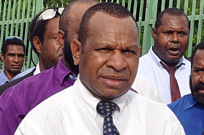 PNG politician Belden Namah walks to Government House in Port Moresby.