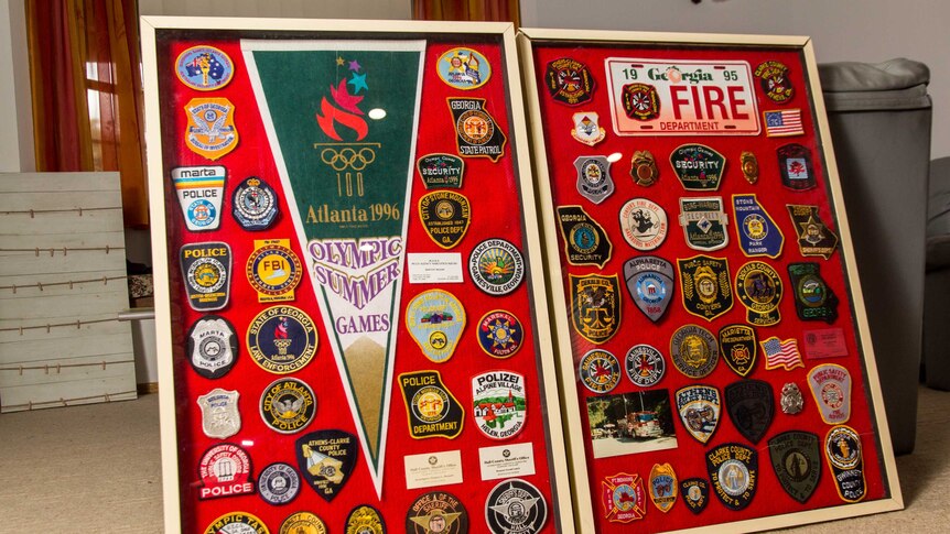 Two pin boards lean against a lounge covered in badges and patches.