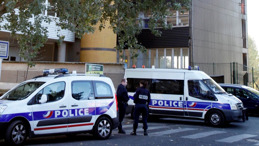 French police stand in front of the offices of the French satirical weekly, Charlie Hebdo.