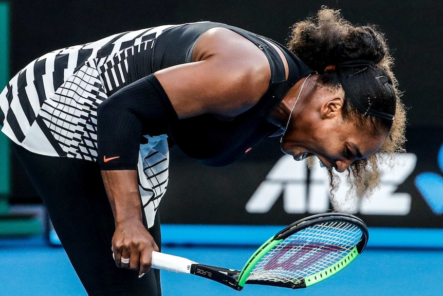 Serena Williams breaks a racquet in frustration during the opening set against sister Venus.