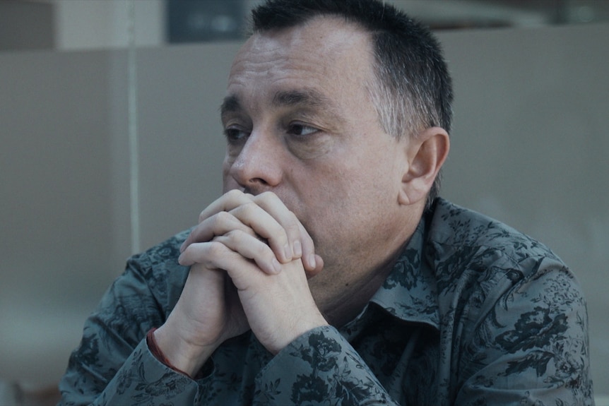 A still from the documentary Collective of a middle aged man - Cătălin Tolontan - looking concerned