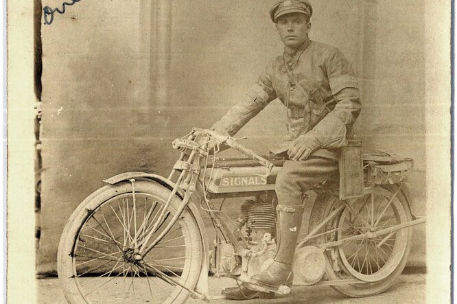 An Australian soldier sits on a motorbike in his uniform. The image, dated 1918, taken in Vignacourt, France.