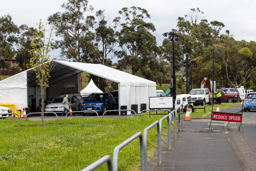 Cars line up to enter a tent set up for Covid-19 testing