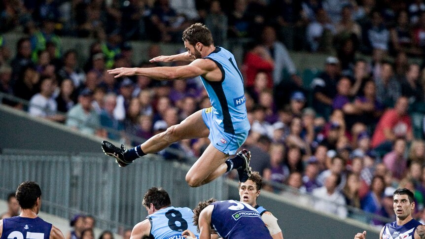 Sky Blue ... Andrew Walker soars above the pack for Carlton.