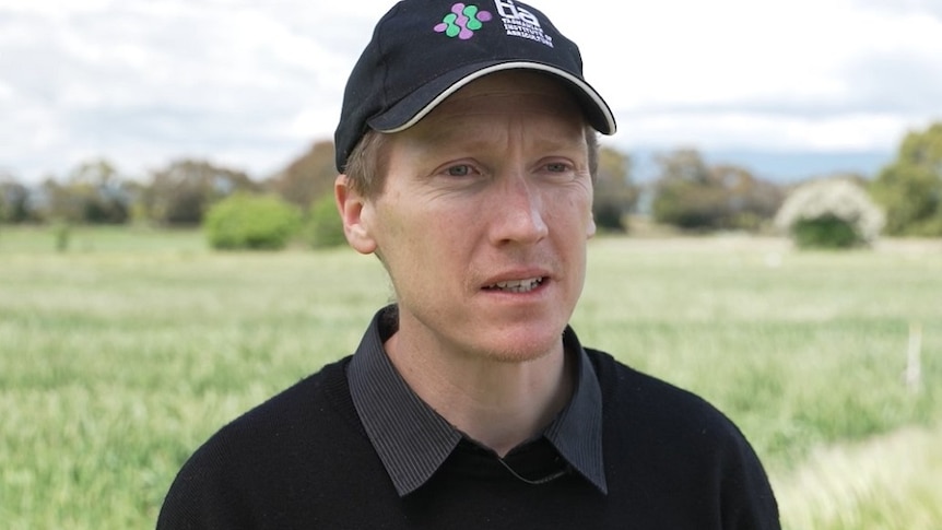 A man wearing a cap looking at the camera and talking about carbon farming