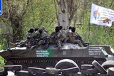 Pro-Russian militants sit on tank in Donetsk