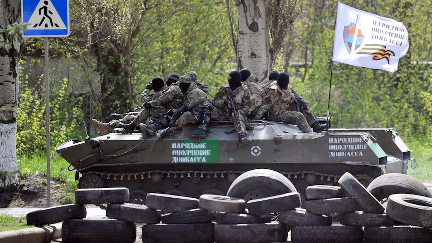 Pro-Russian militants sit on tank in Donetsk