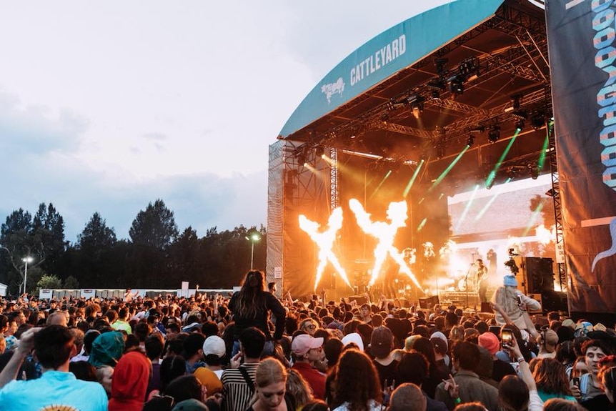 Pyrotechnics go off as a crowd watches The Amity Affliction at Groovin The Moo