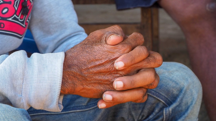 A shot of a man's clasped hands