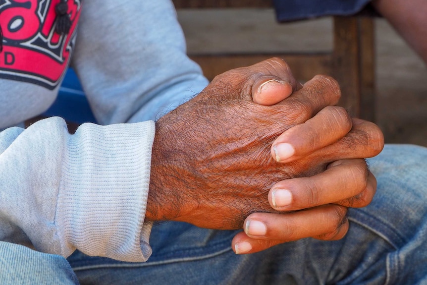 A shot of a man's clasped hands