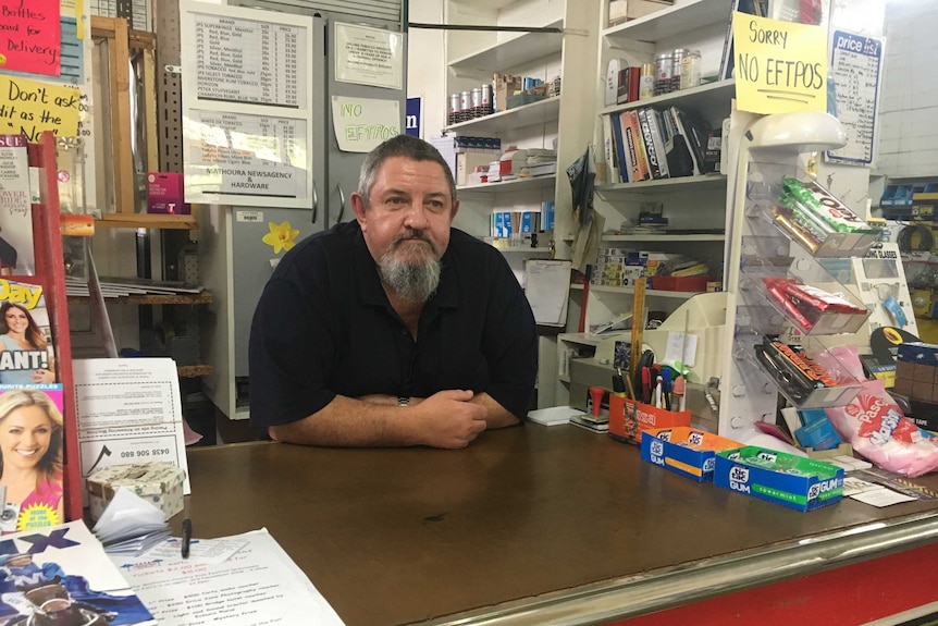 Mathoura Newsagency and Hardware owner Kevin Laws standing behind the counter of his store