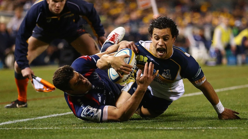 The Brumbies' Matt Toomua scores a try against the Rebels at Canberra Stadium on May 31, 2014.