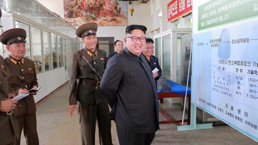 North Korean leader Kim Jong-Un smiles during a visit to the Chemical Material Institute.