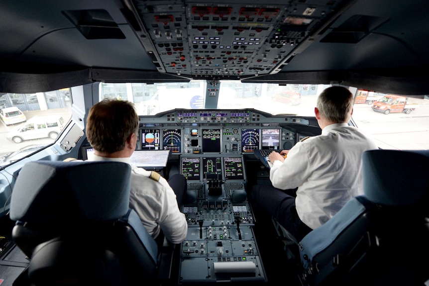 Two pilots in a cockpit of an airbus A380 plane