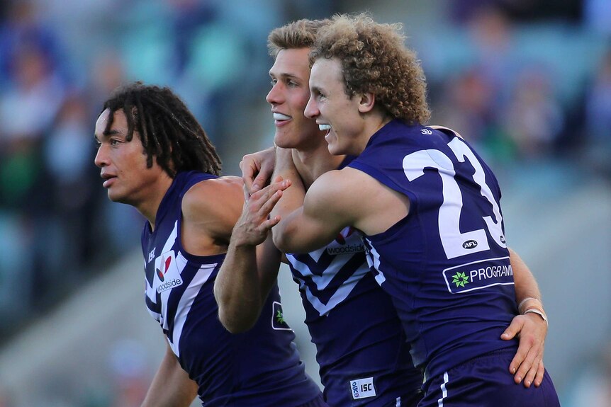 Tendai Mzungu, Matt de Boer and Chris Mayne celebrate a goal for the Dockers against GWS.