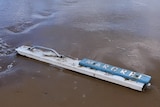 A screenshot of footage showing  sign from the ship of missing man Tony Higgins, the Margrel, found washed up on a Goolwa beach.