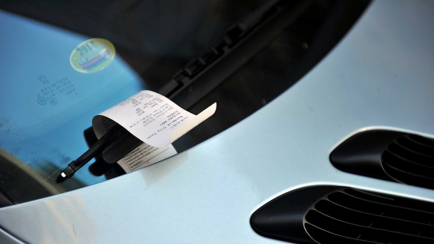 A parking fine on a windscreen.