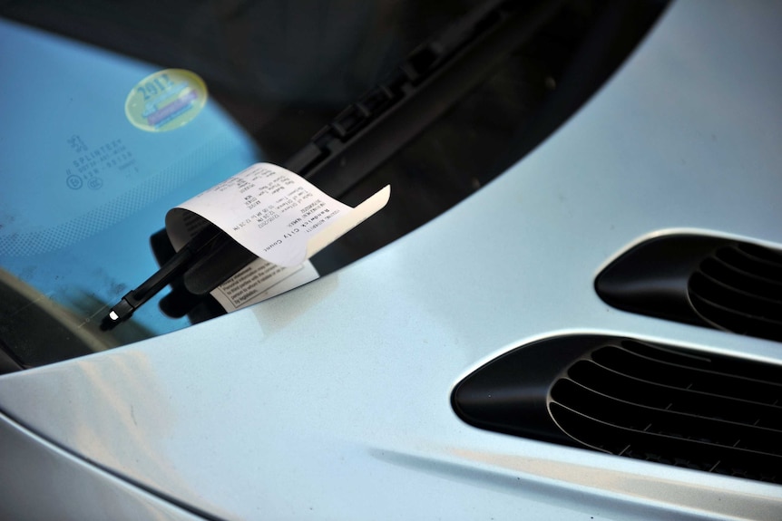 A parking fine on a windscreen.