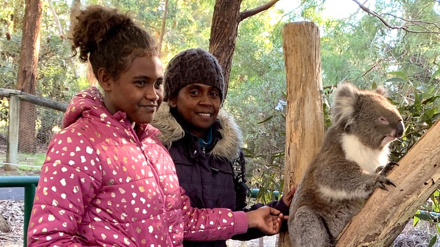 Georgina Auna with mother Andrea and a koala at Cleland Wildlife Park.