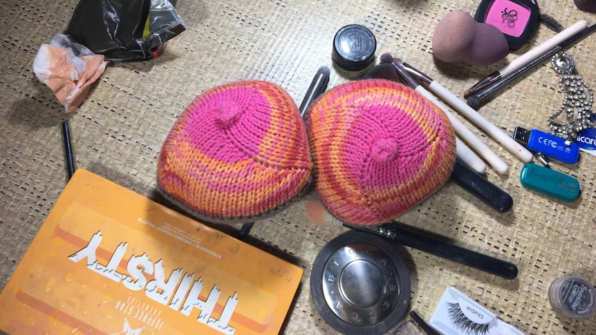 A couple of knitted balls in the shape of boobs sit on the make up table.