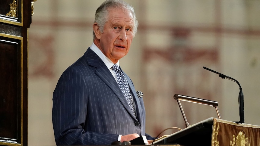 King Charles III speaks from an ornate lectern
