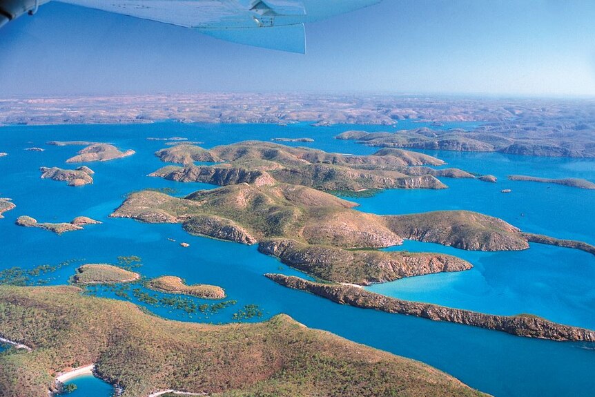 Aerial image of a stunning archipelago of green islands across crystal blue waters.