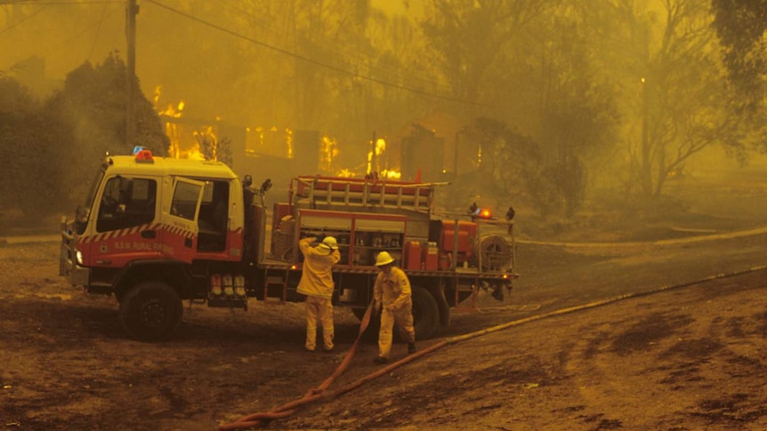 Fire crews working on a burning house in Kambah