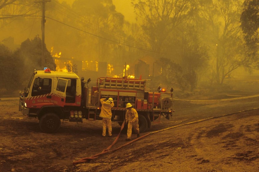 Fire crews working on a burning house in Kambah