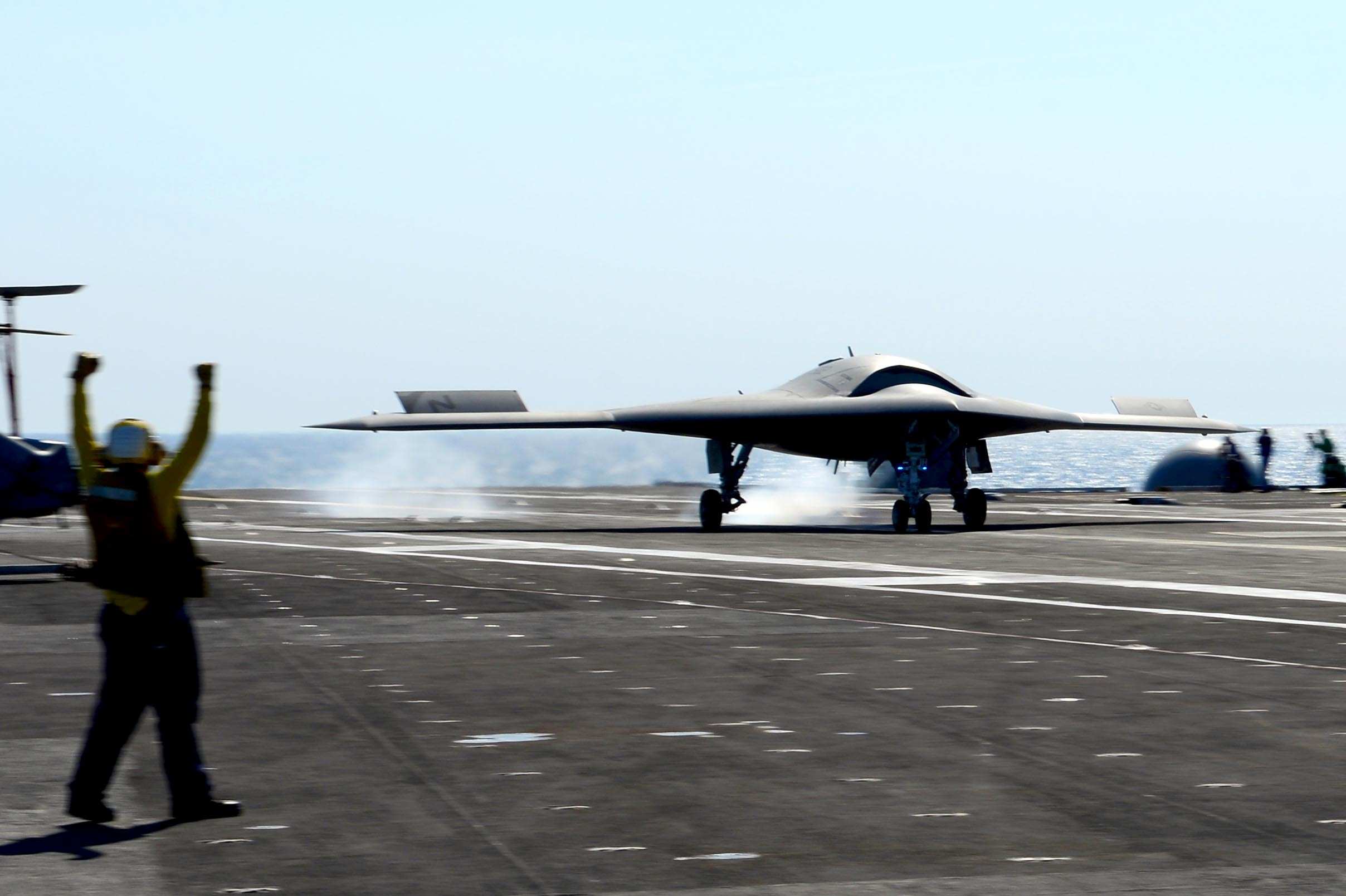 US Navy drone lands on aircraft carrier deck in robotic flight ...