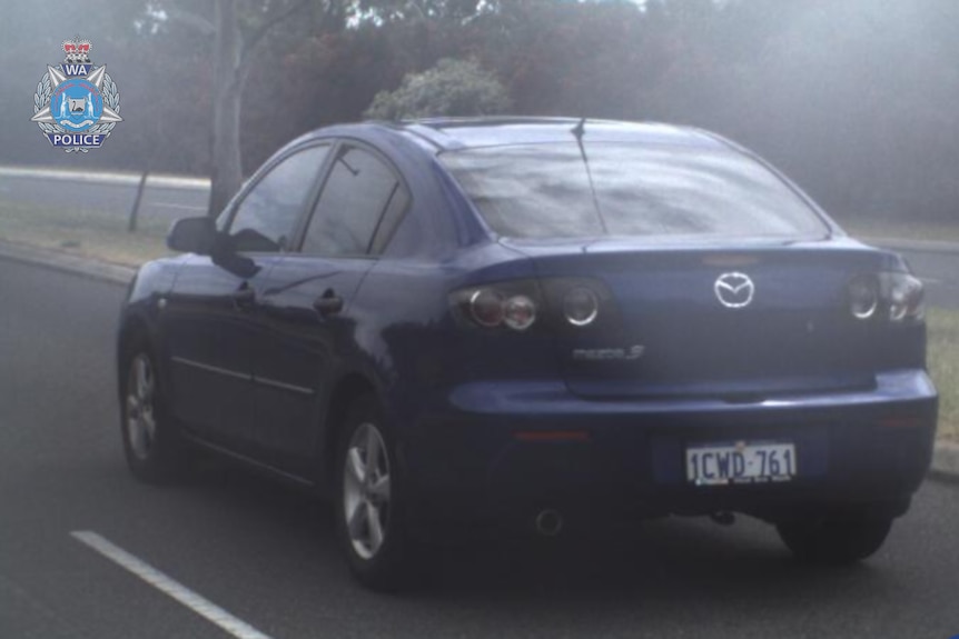 A photograph of a dark blue Mazda 3 sedan.