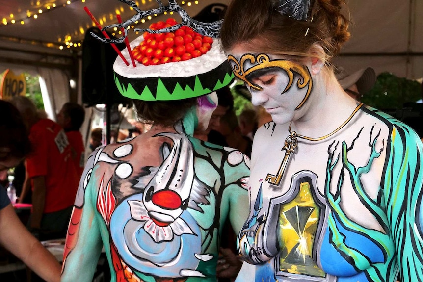 A group of models in full colourful body paint