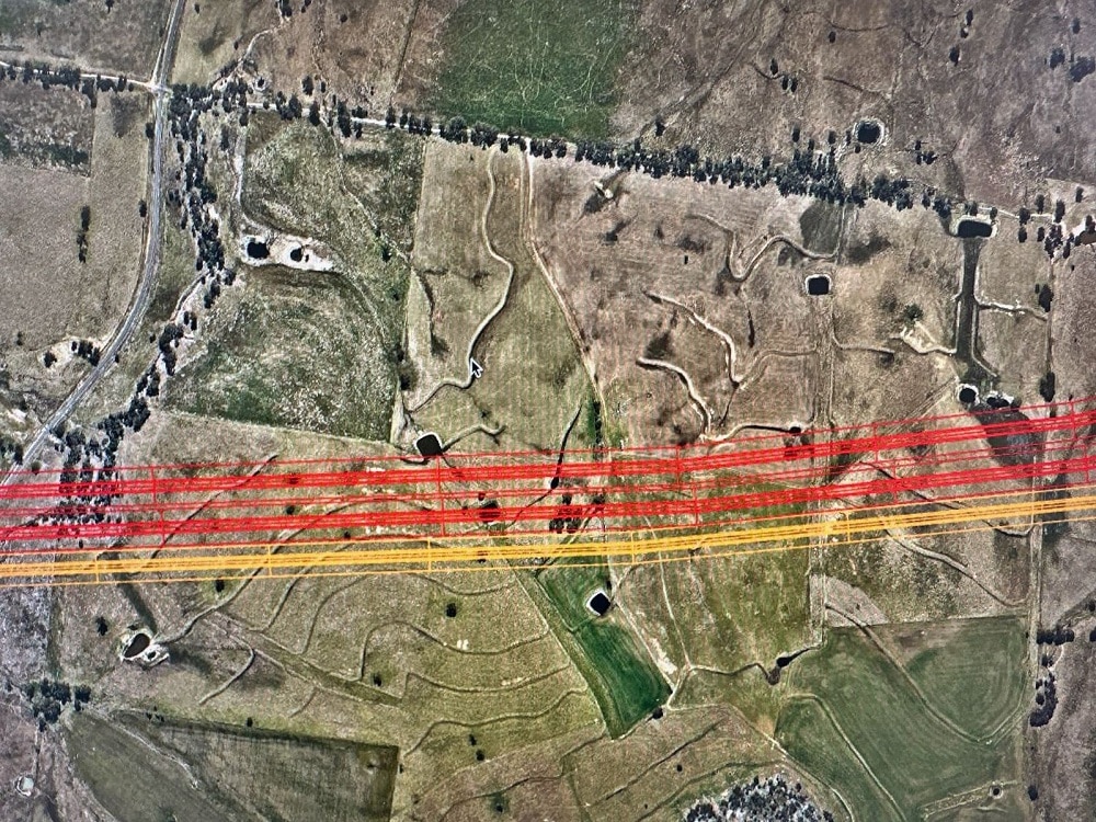 Aerial shot of farm with transmission lines marked in red