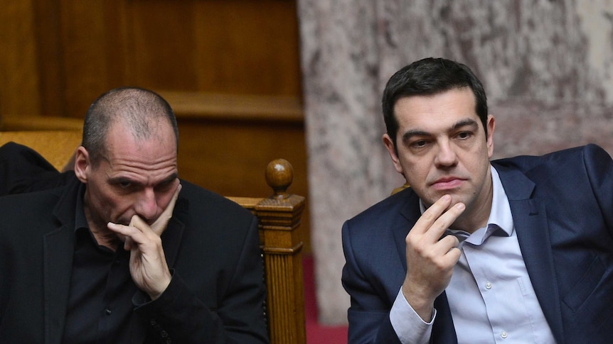 Greek prime minister Alexis Tsipras (R) sits along side finance minister Yianis Varoufakis
