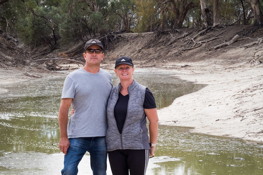 Paddlesteamer operators Michelle and Chris Pointon smiling in front of the Darling River.
