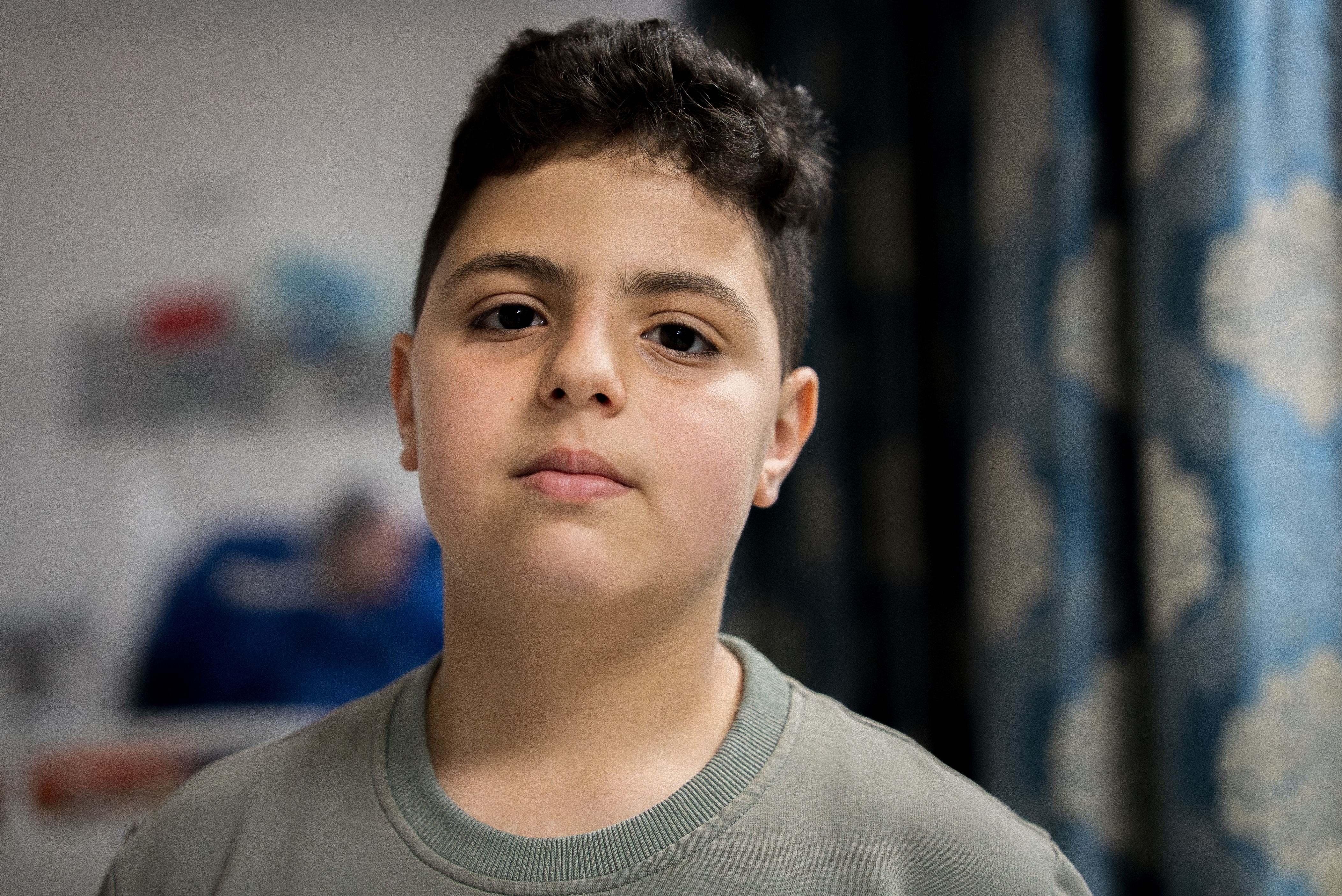 A close up of a young boy looking sad.