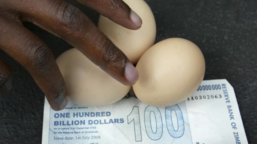 A vendor arranges eggs on a 100 billion Zimbabwean dollar note