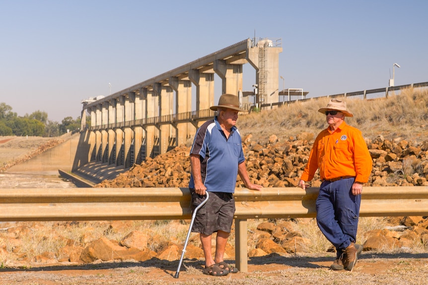 Sam Saunders and Ron Waters lean on a guard rail near the E.J Beardmore Dam, near St George, Queensland, August 2023.